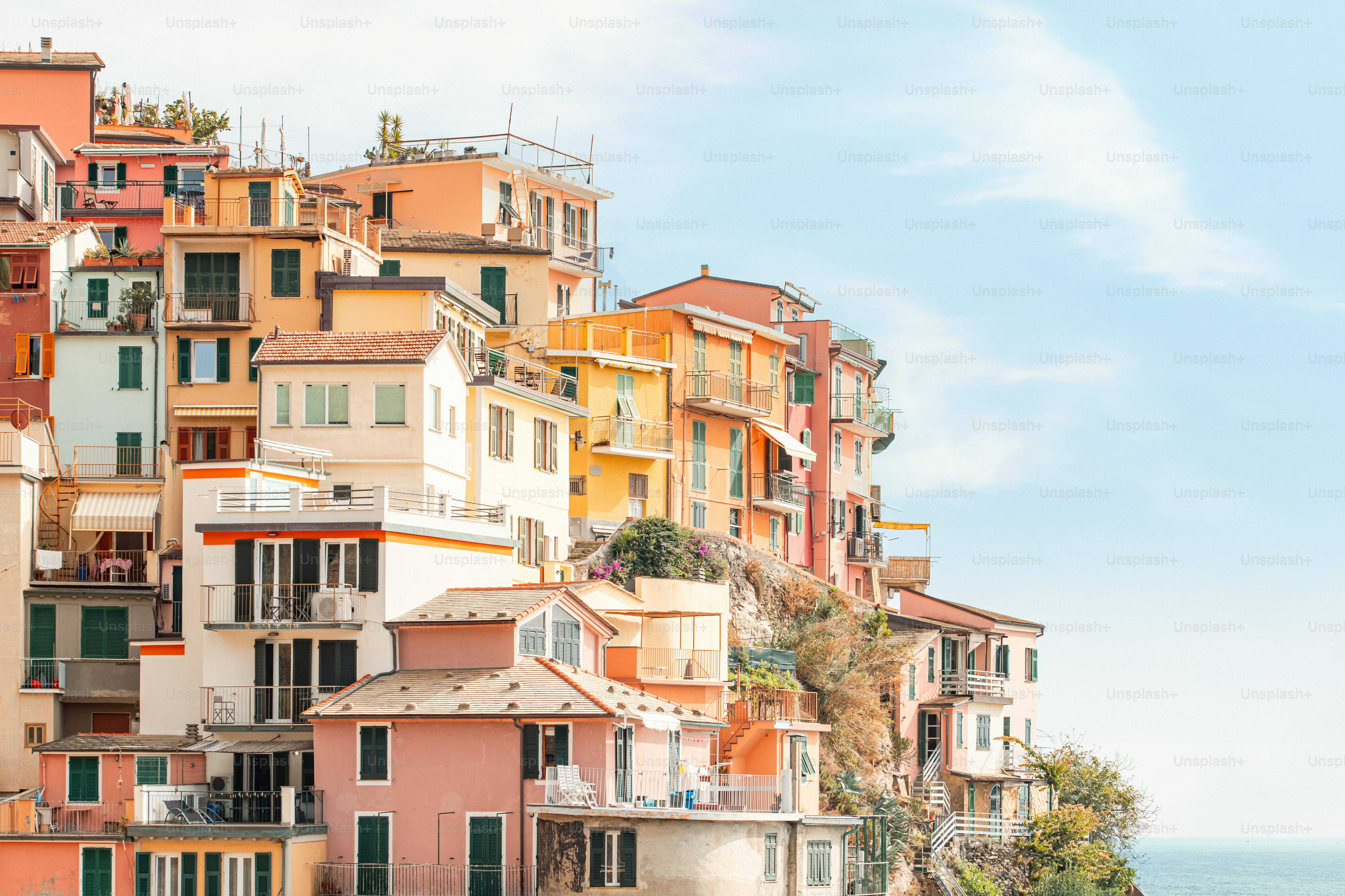 a group of buildings on a hill with a body of water in the foreground