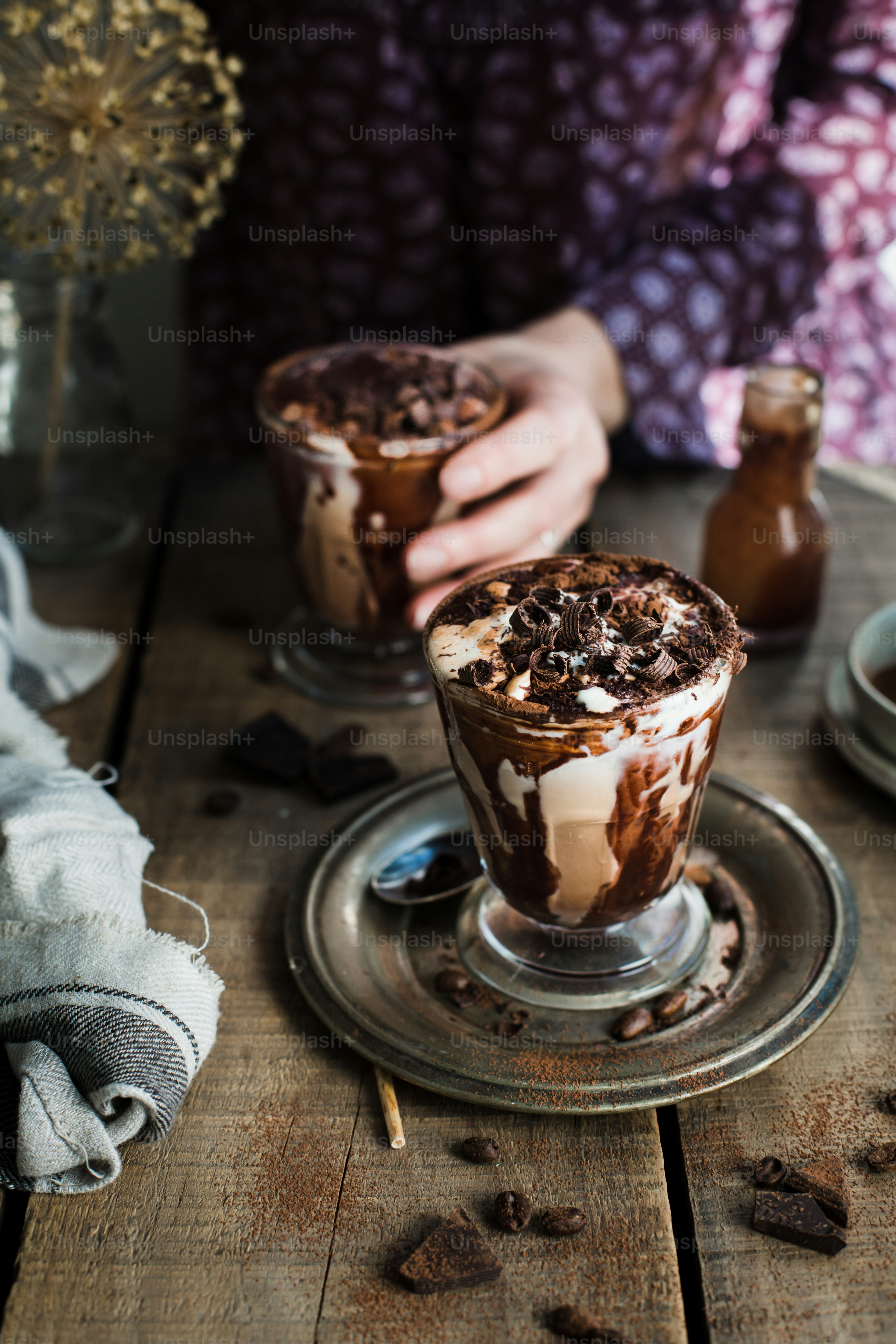 two glasses of ice cream on a wooden table