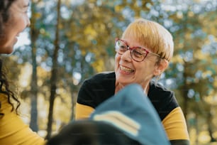 a woman with glasses talking to another woman