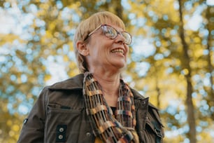 a woman wearing glasses and a scarf smiling