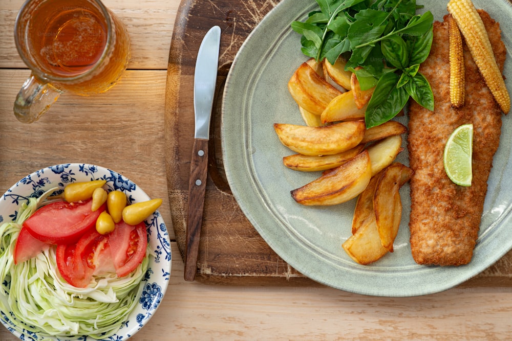 a plate of fish and fries with a side of coleslaw