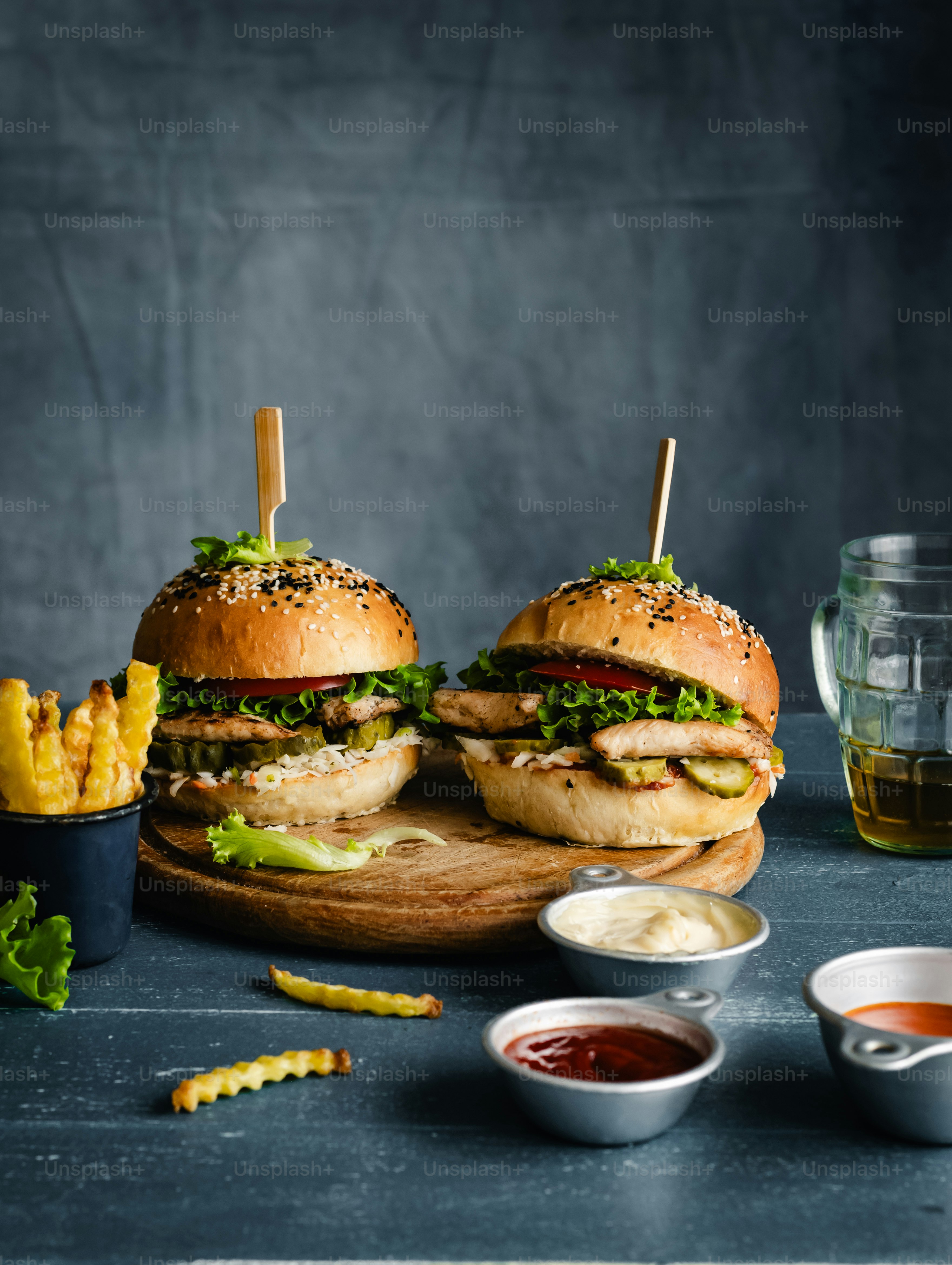 a couple of sandwiches sitting on top of a wooden cutting board