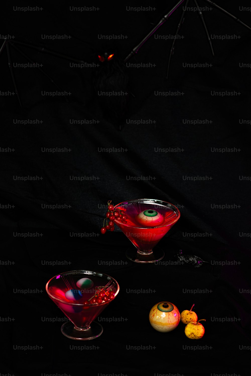 a couple of glasses filled with liquid on top of a table