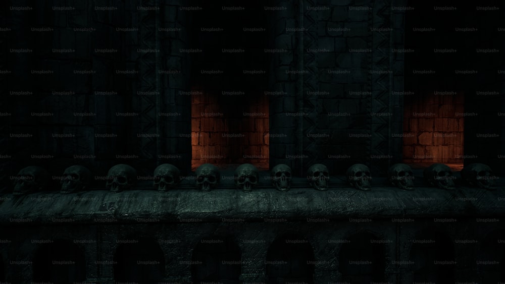 a row of skulls sitting on top of a stone wall