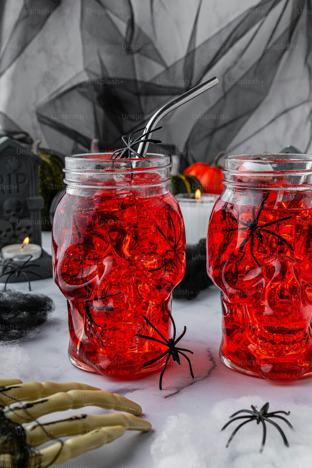 a couple of jars filled with red liquid