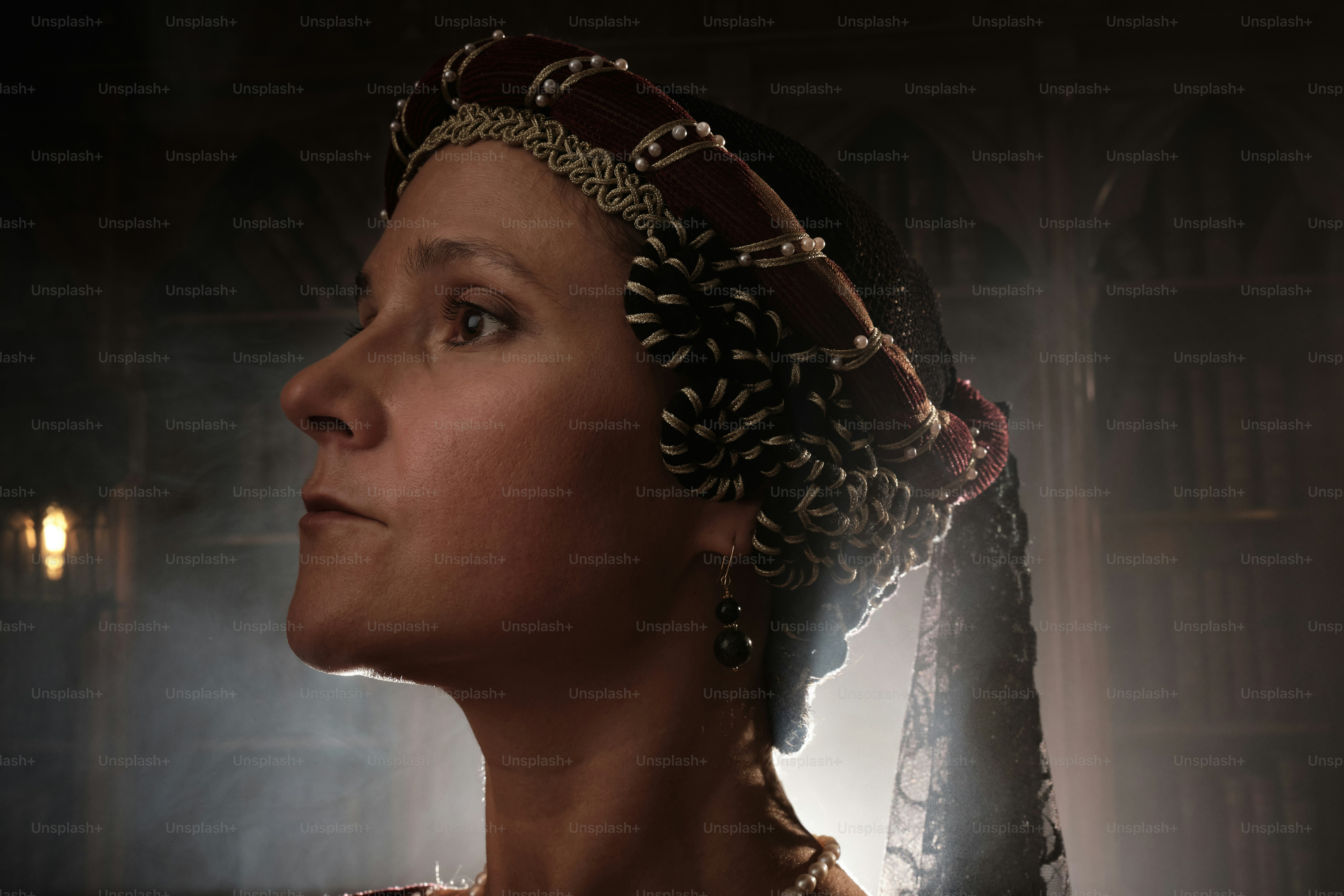 a woman wearing a tiara in a dark room