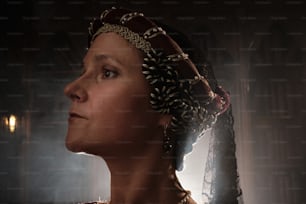 a woman wearing a tiara in a dark room