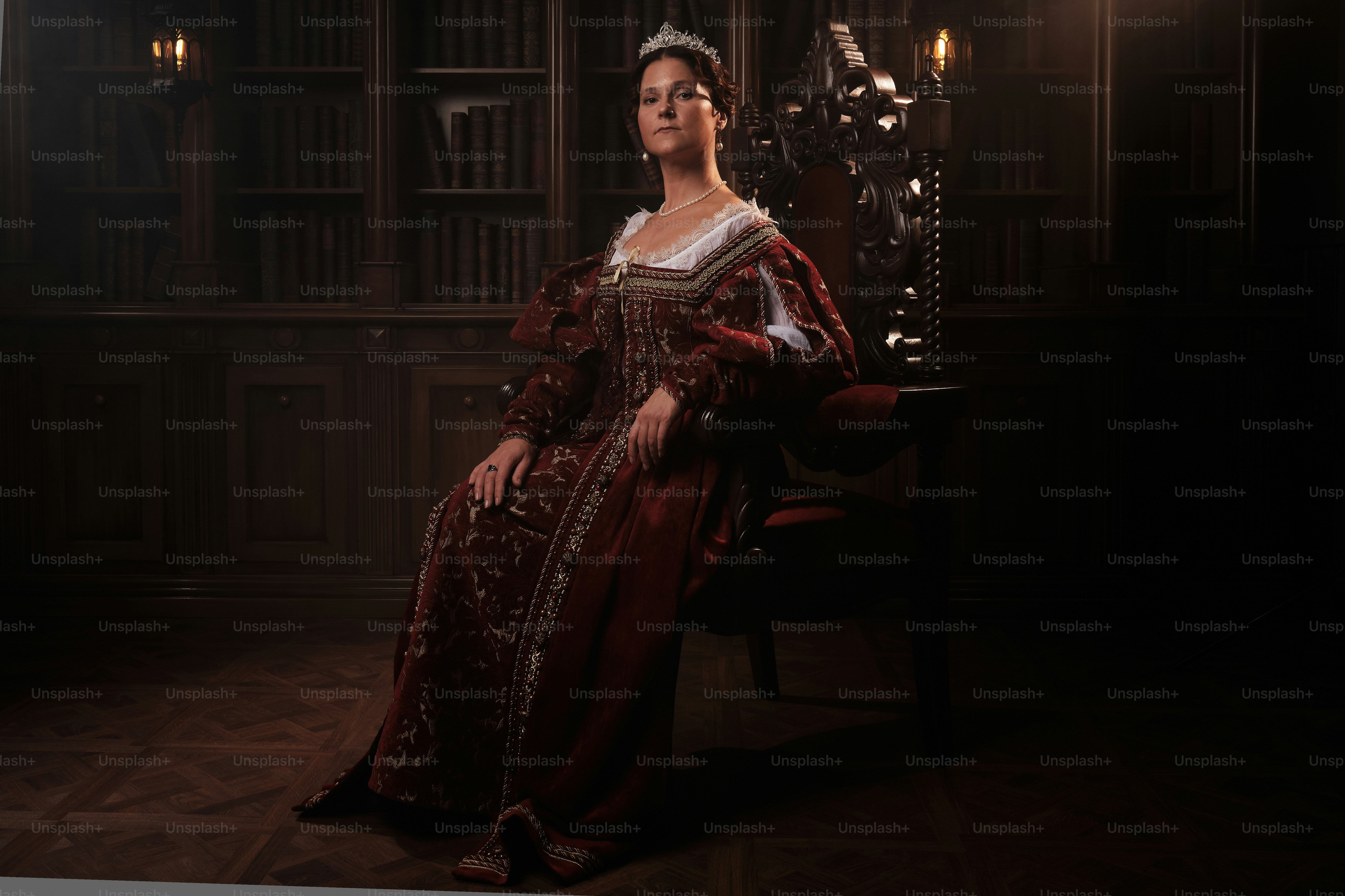 a woman in a red dress sitting in a chair