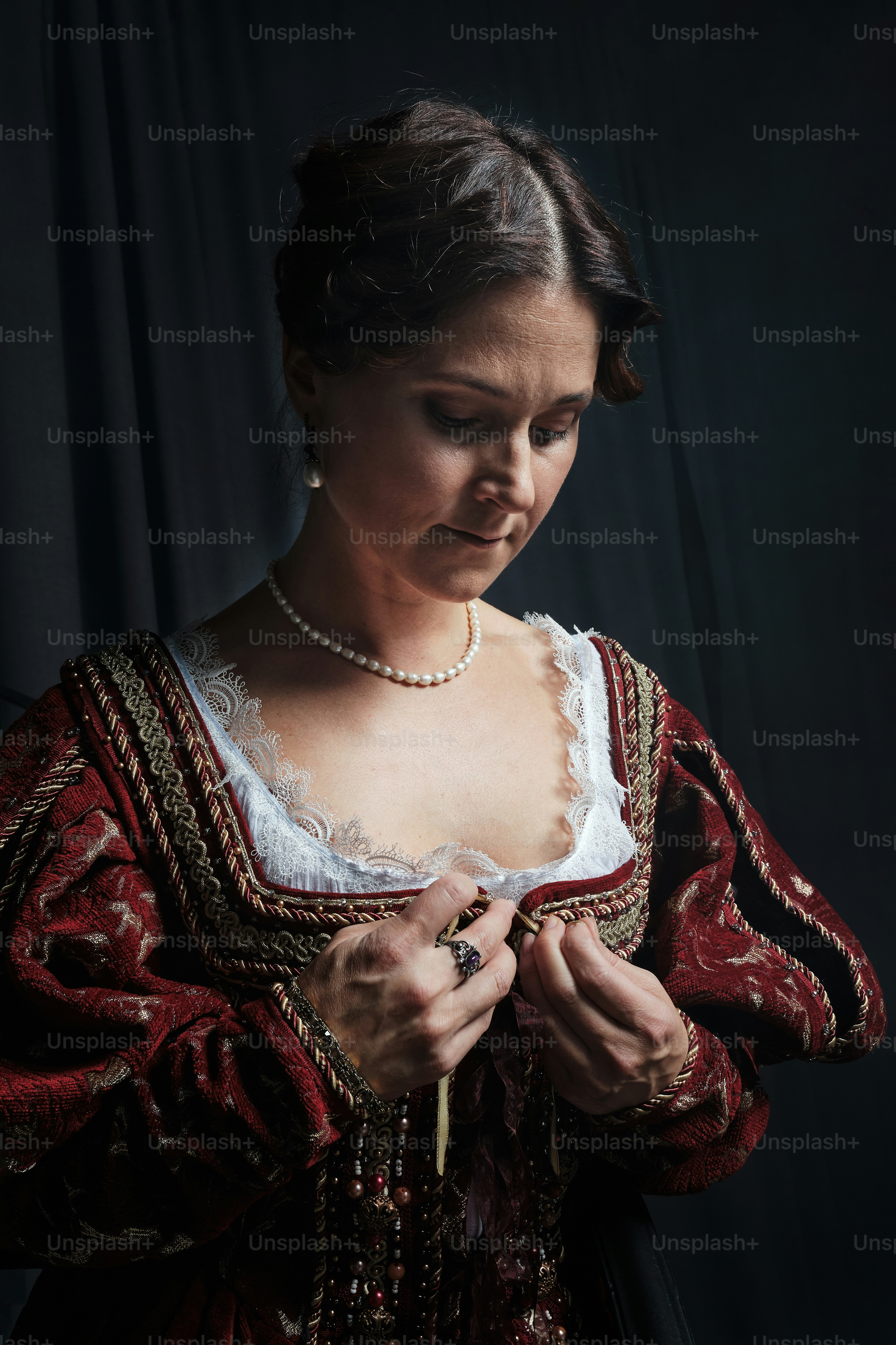 a woman in a red and white dress is holding something
