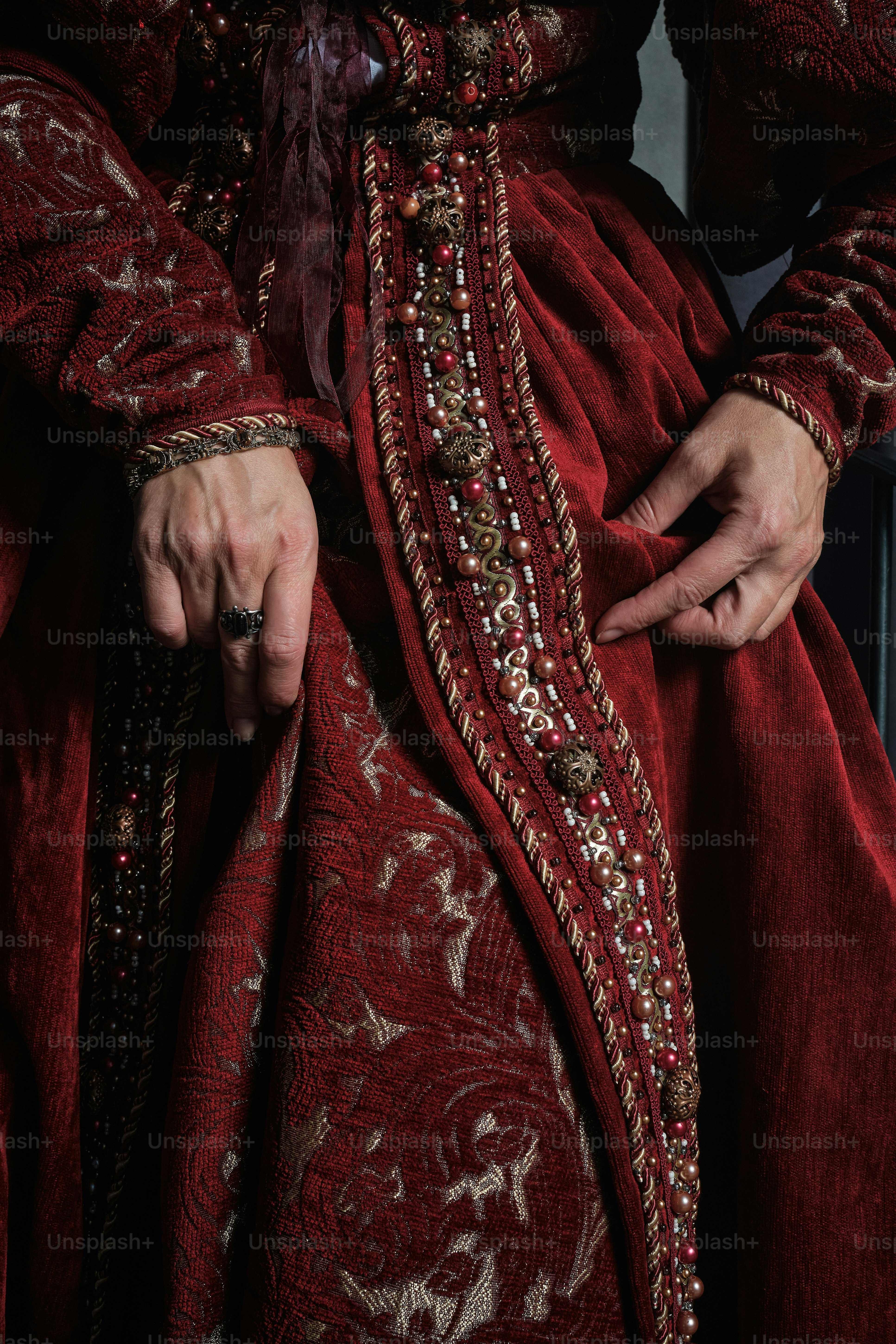 a close up of a person wearing a red dress
