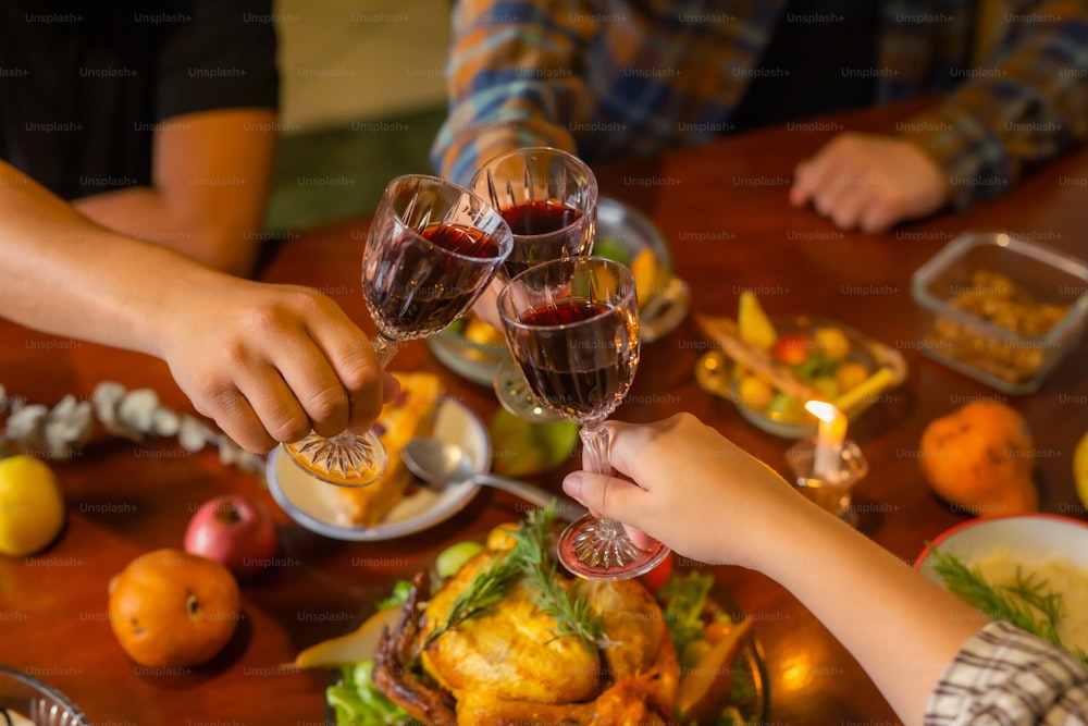 a group of people toasting wine glasses over a turkey