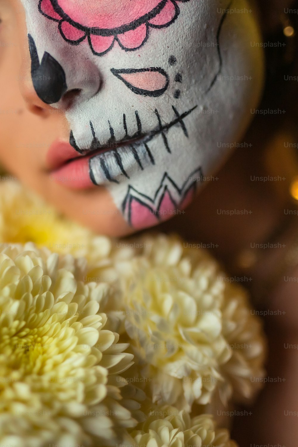 a young girl with face paint and flowers