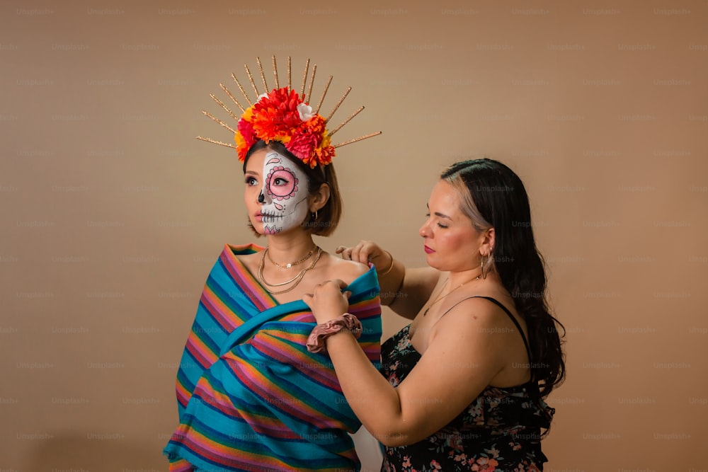 two women with painted faces are posing for a picture