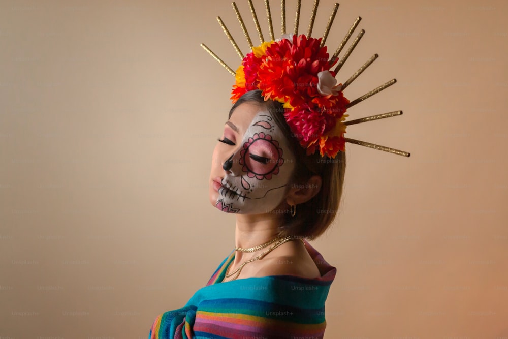 a woman with a skeleton face paint and flowers in her hair