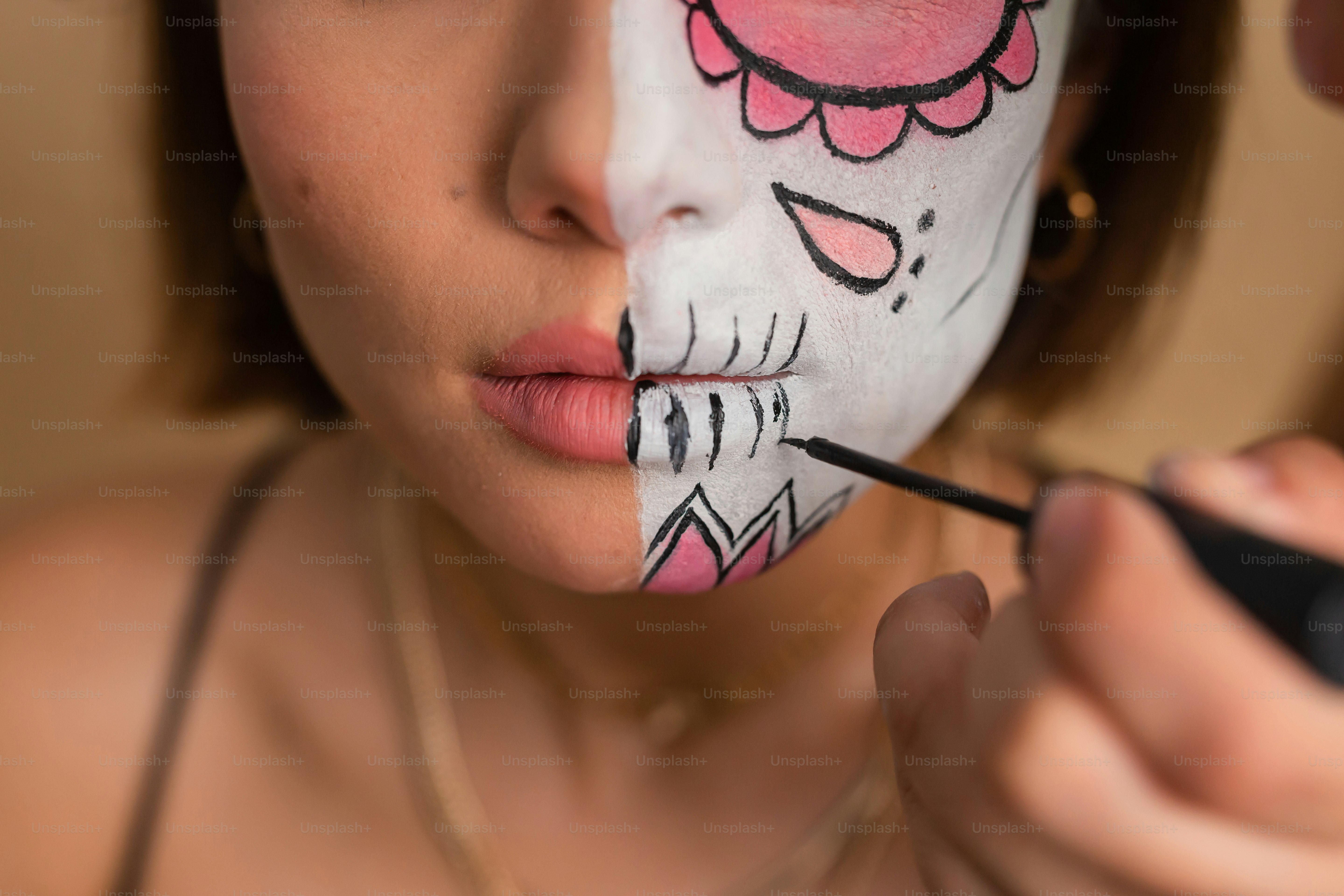 a woman is getting her face painted