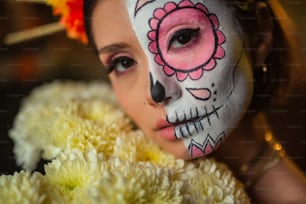 a young girl with a skull painted on her face