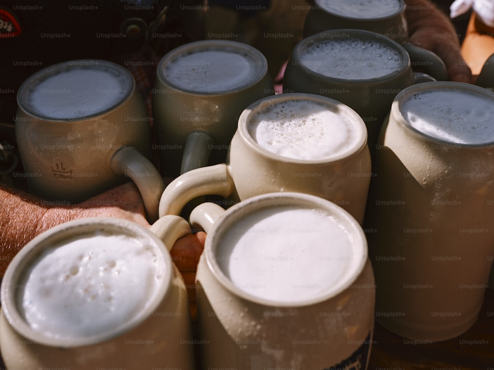 a bunch of beer mugs sitting next to each other