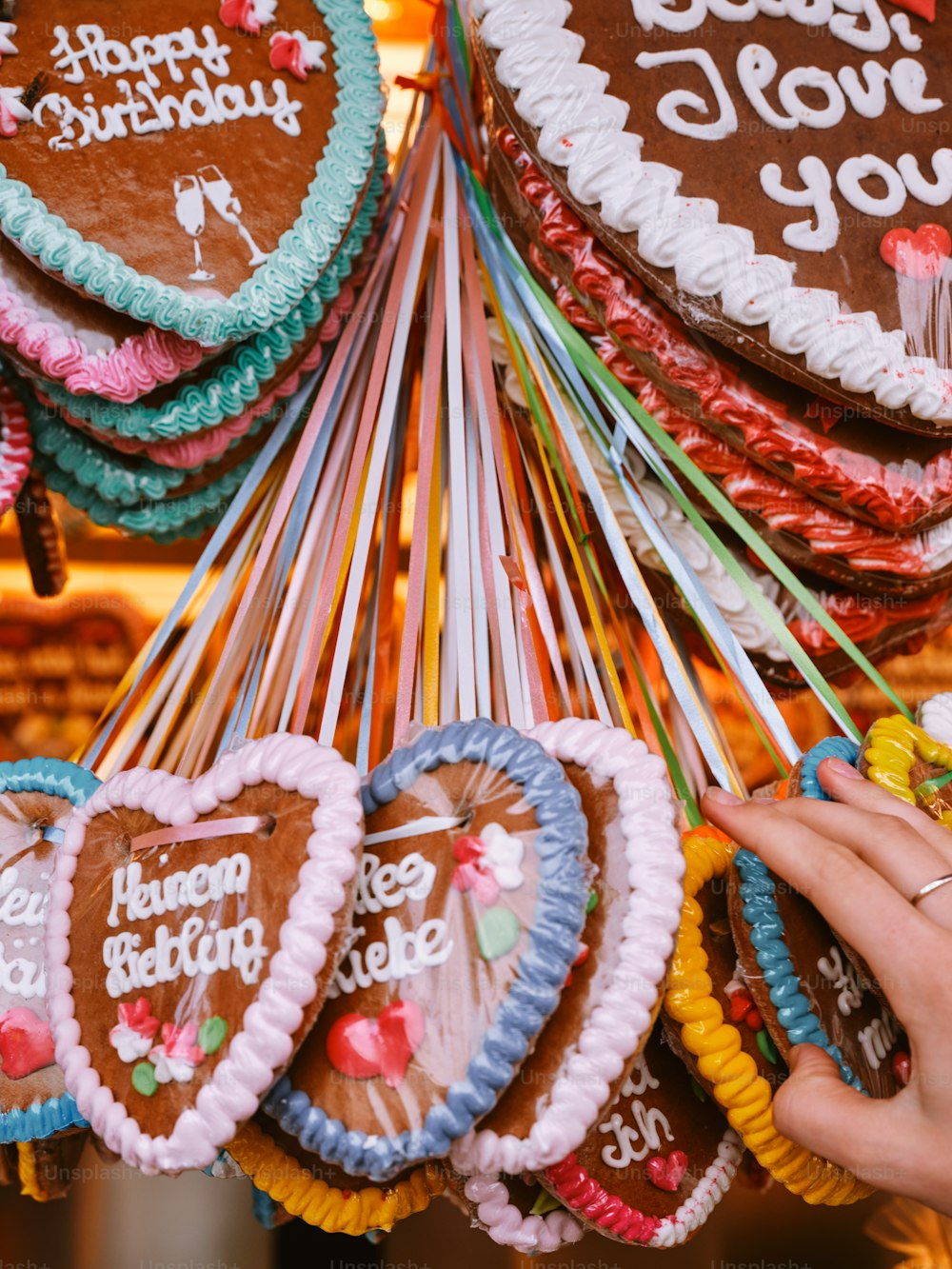 a person holding a bunch of heart shaped cookies