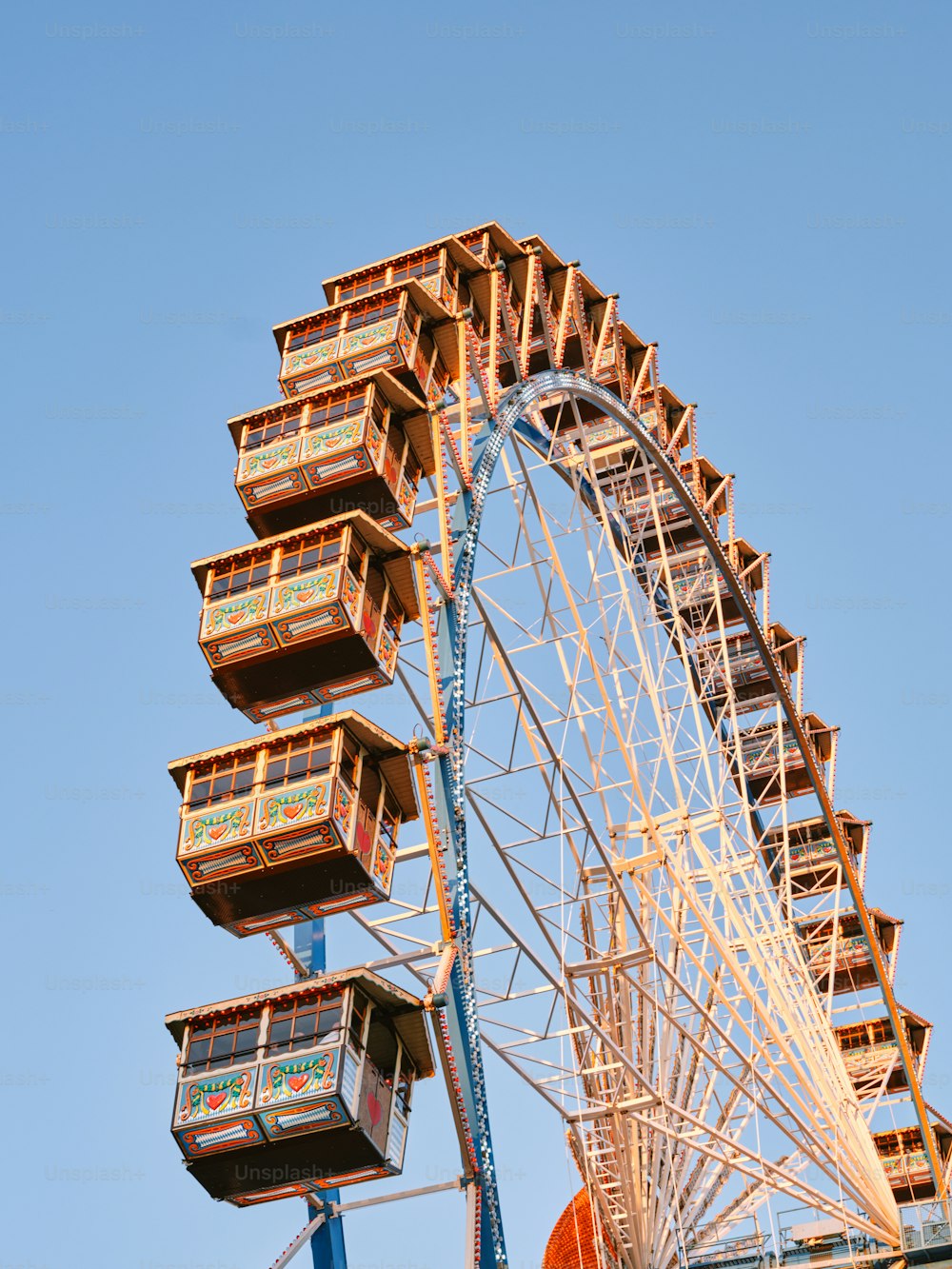a large ferris wheel with multiple wooden boxes on it