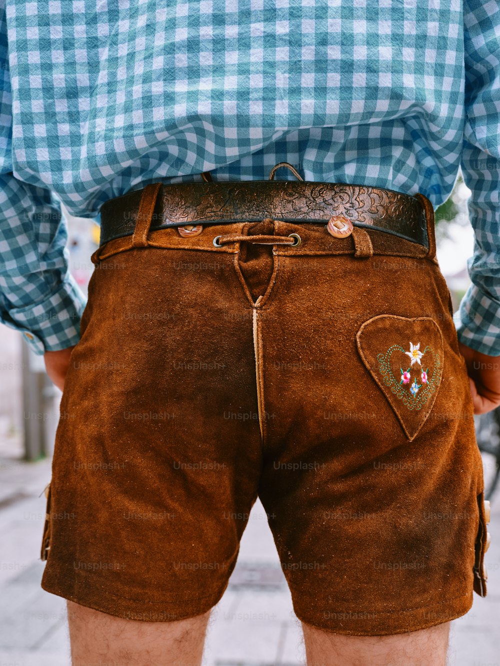 a close up of a person wearing brown shorts