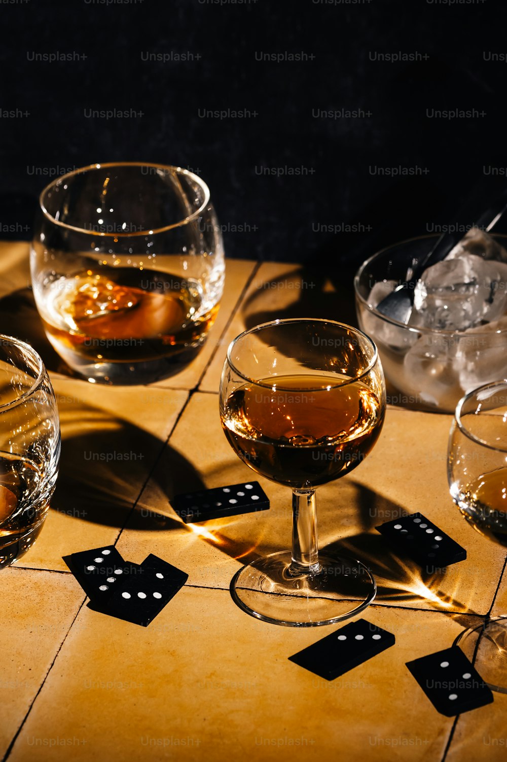 a table topped with glasses of wine and dice