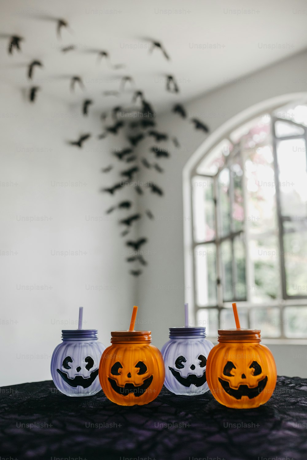 three halloween pumpkin cups sitting on top of a table