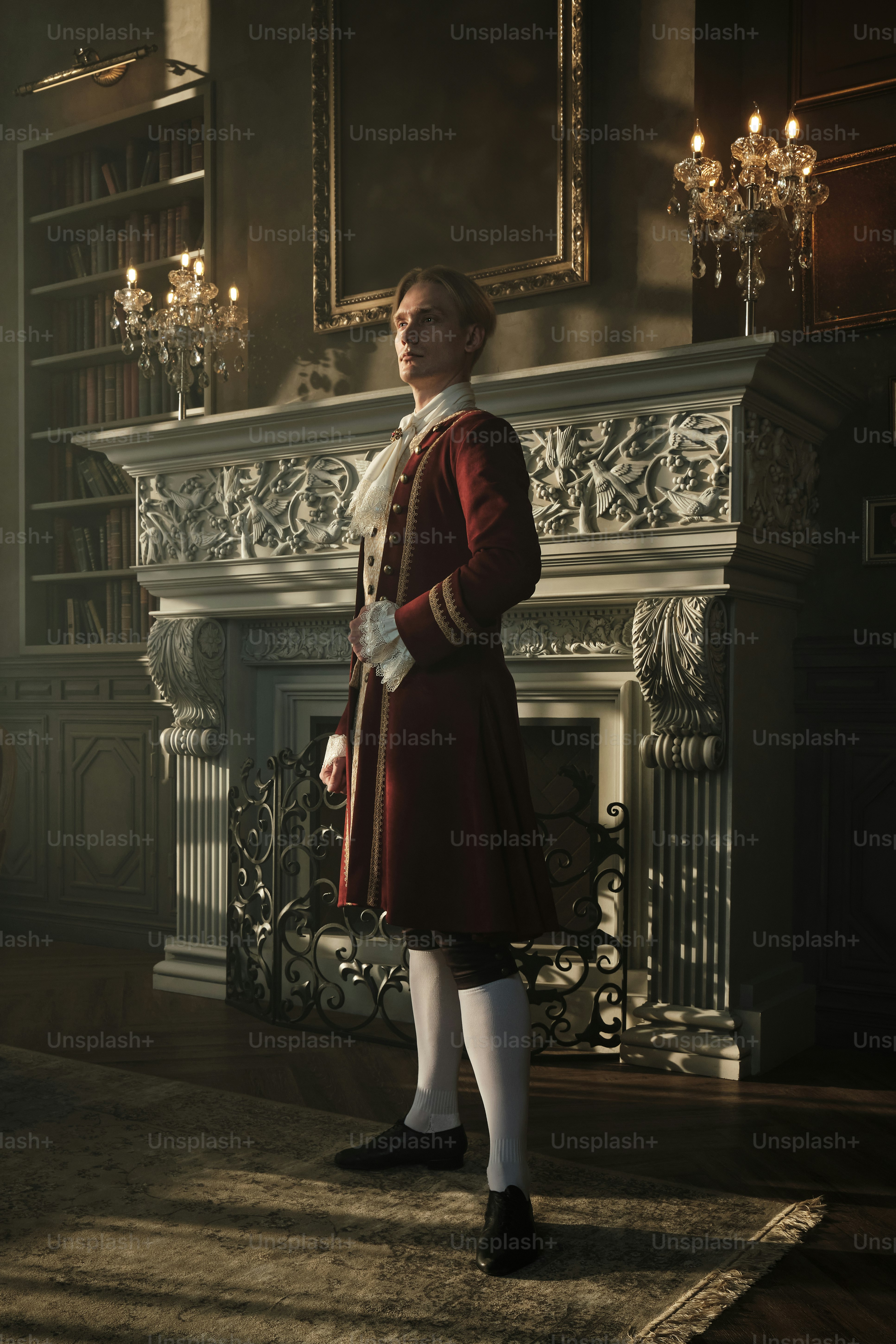 a woman in a red dress standing in front of a fireplace