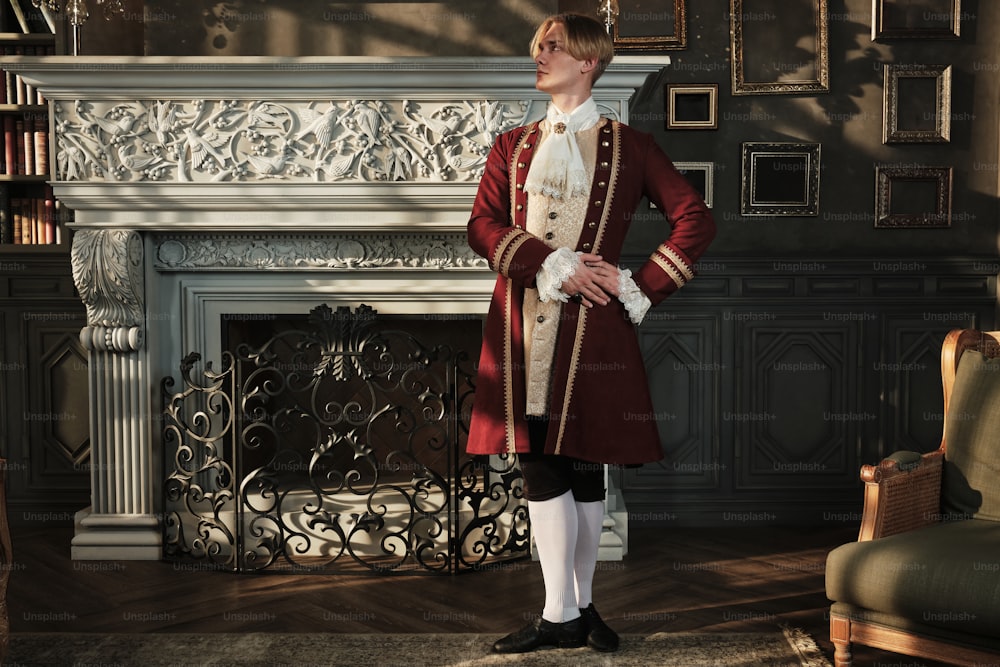 a man in a red uniform standing in front of a fireplace