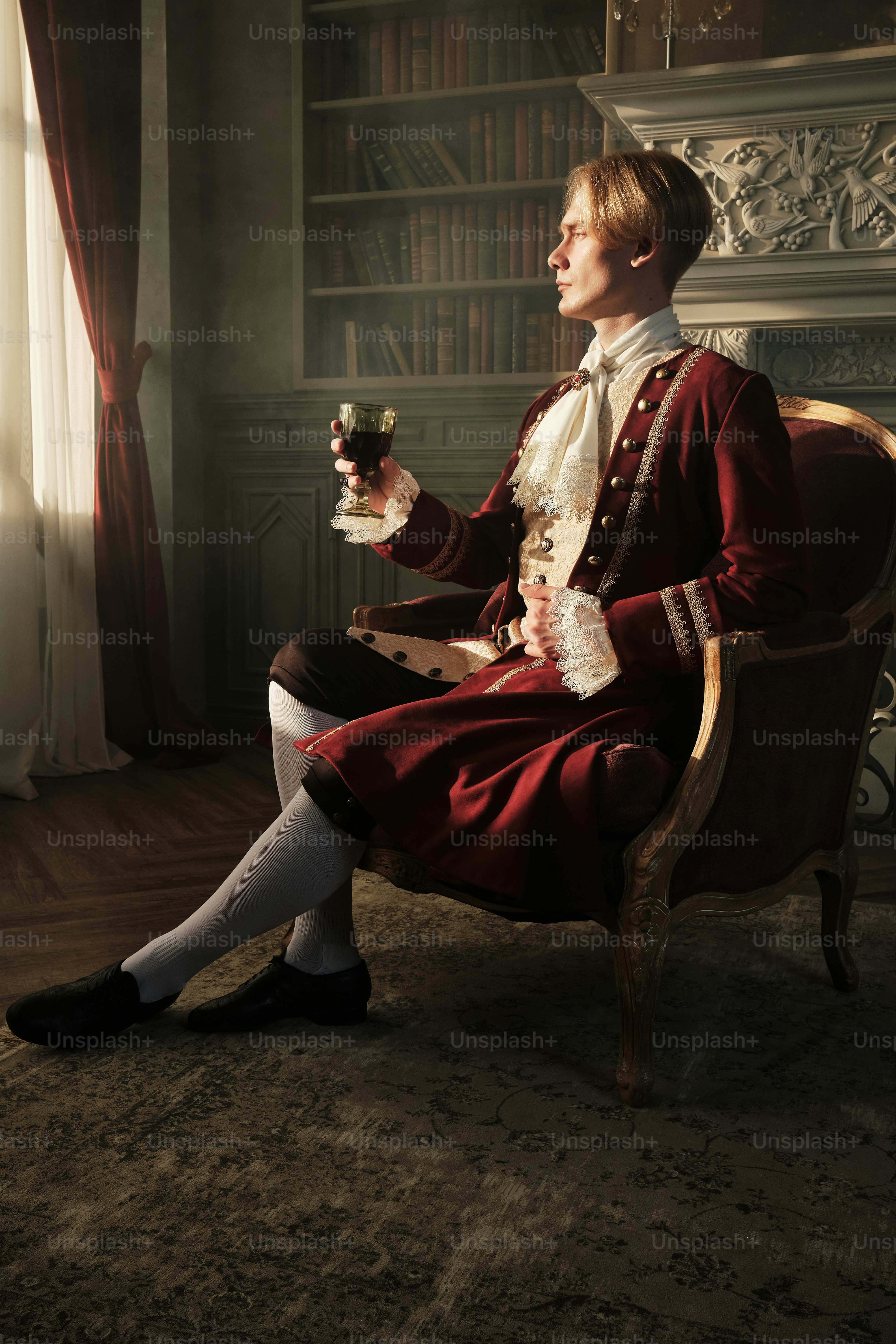 a woman sitting in a chair holding a glass of wine