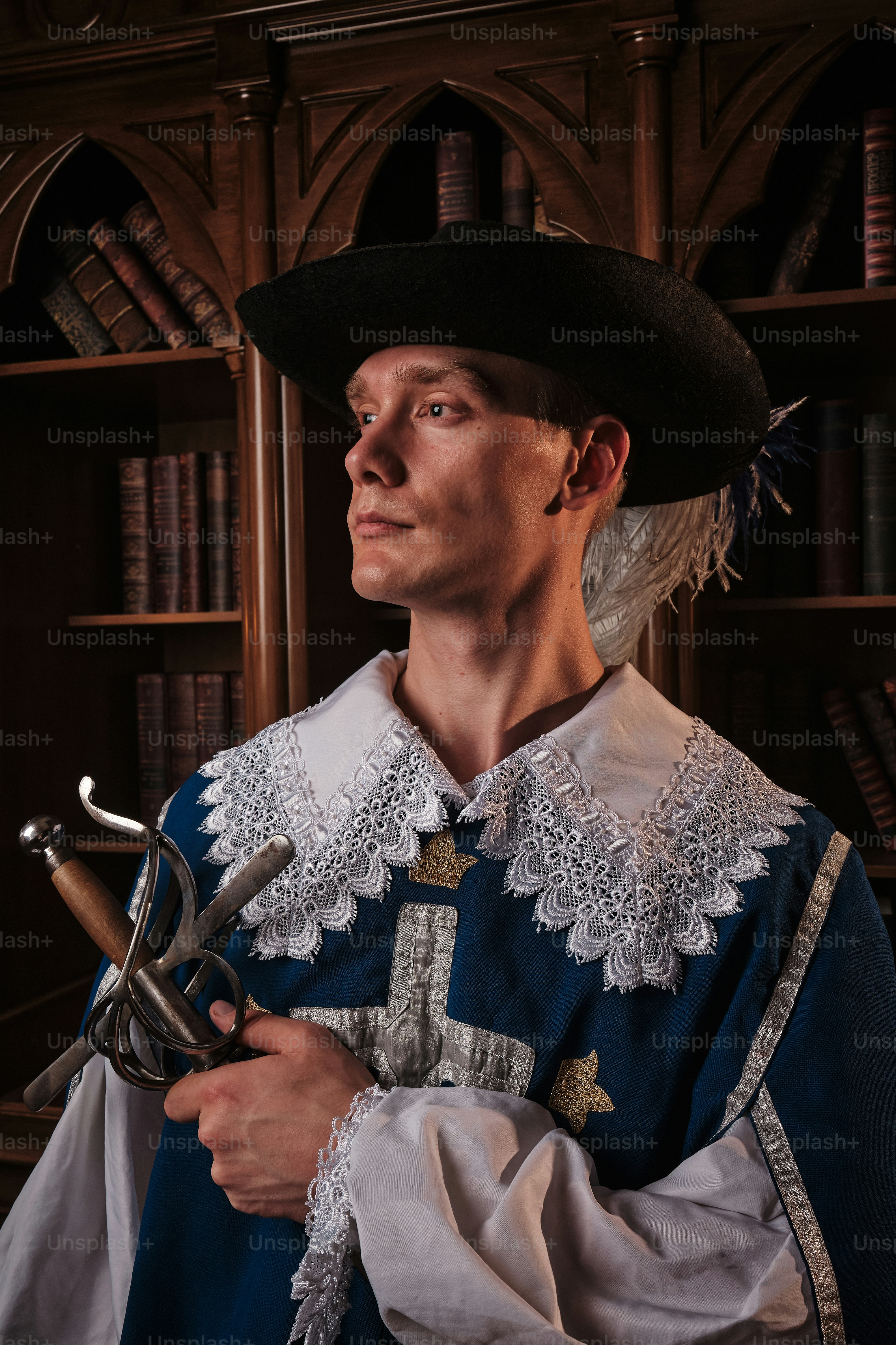 a man in a blue and white outfit holding a pair of scissors