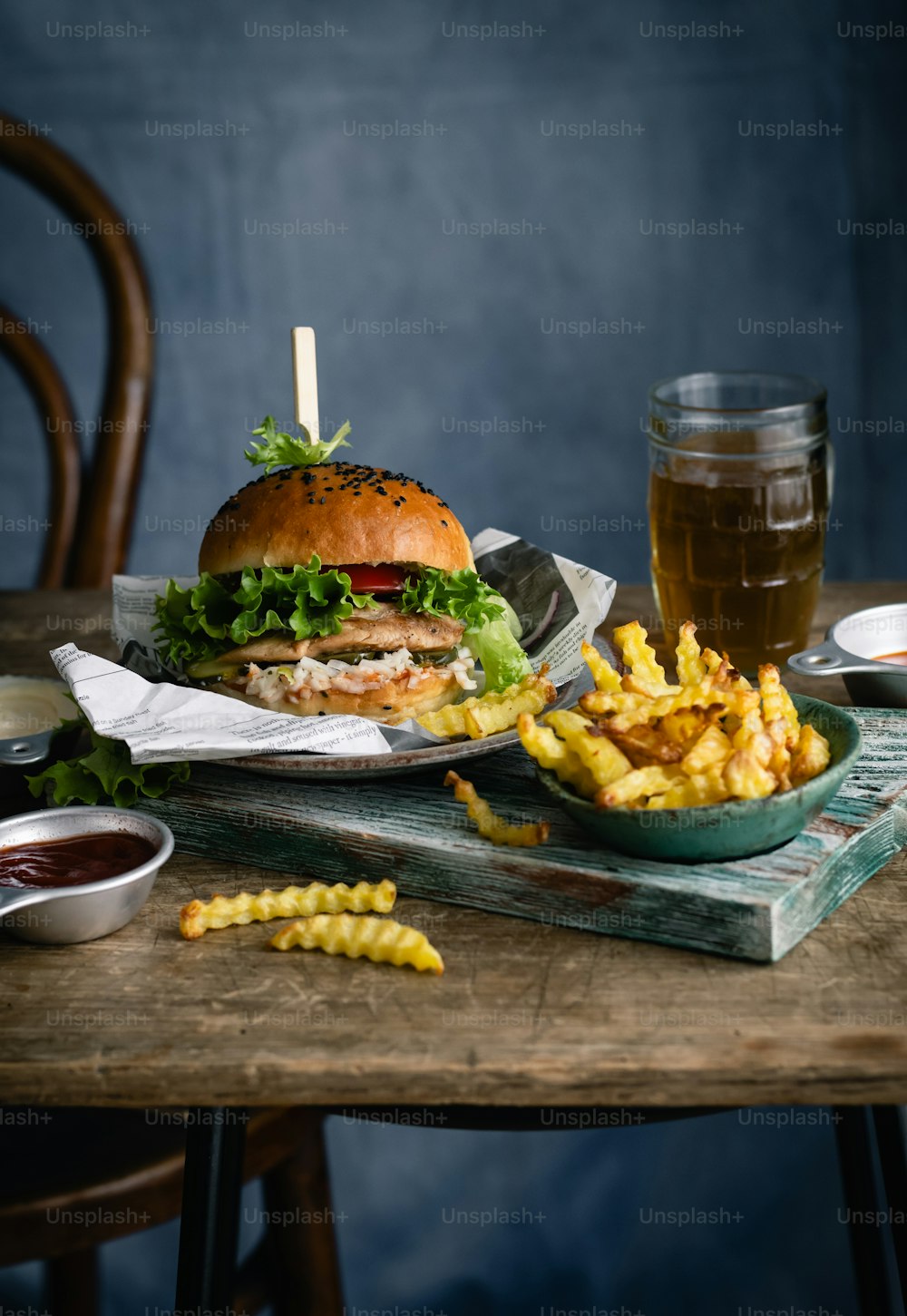 a table topped with a burger and french fries