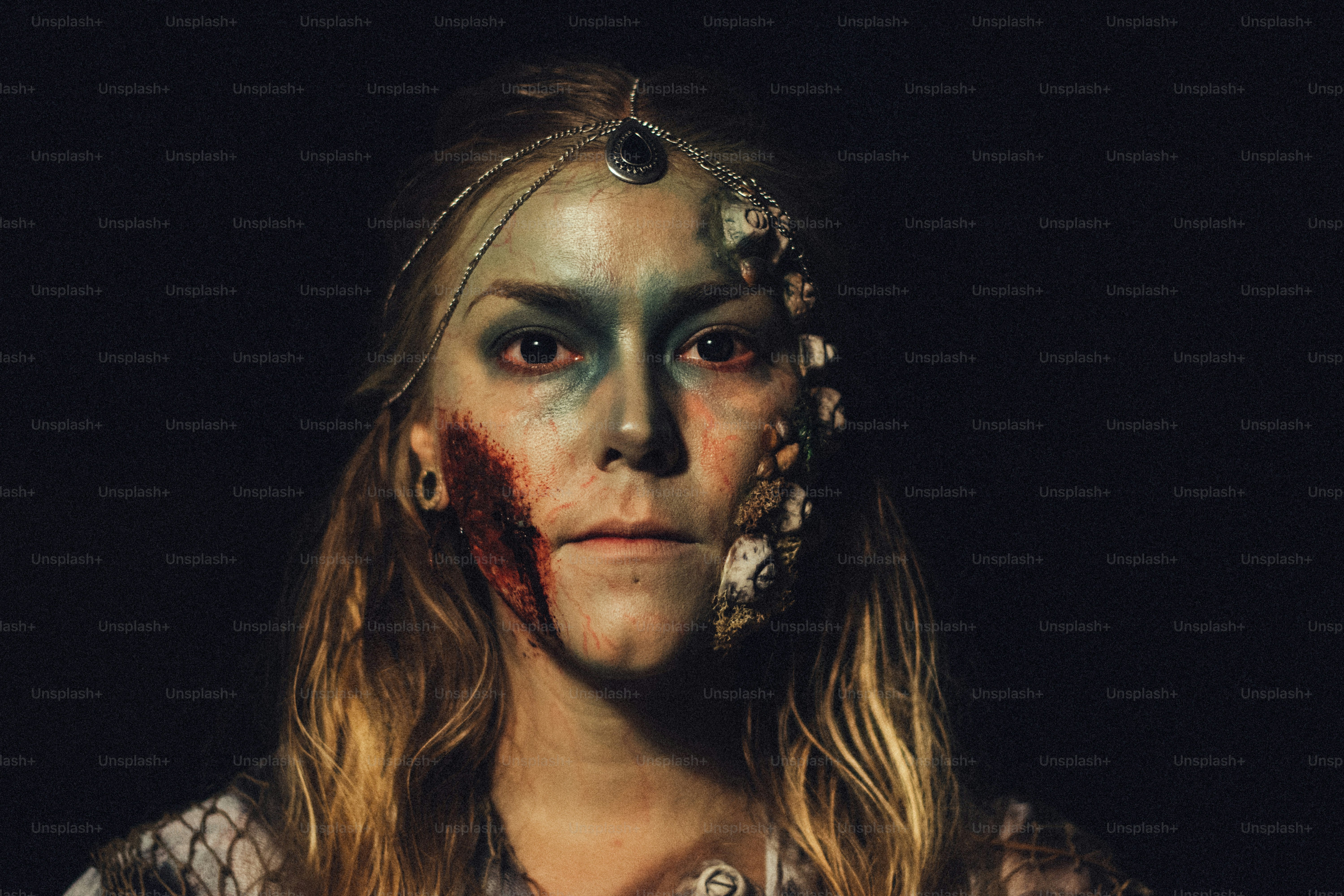 a woman with makeup on her face and blood on her face