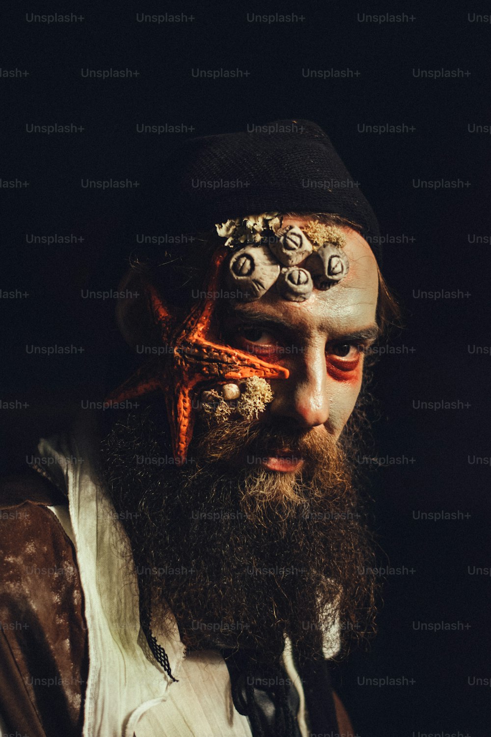 a man with a beard and a starfish on his face