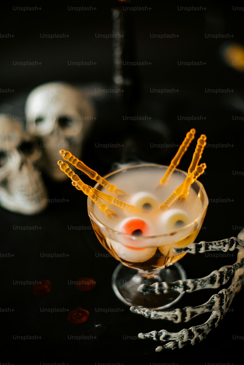 a halloween drink with orange sticks sticking out of it