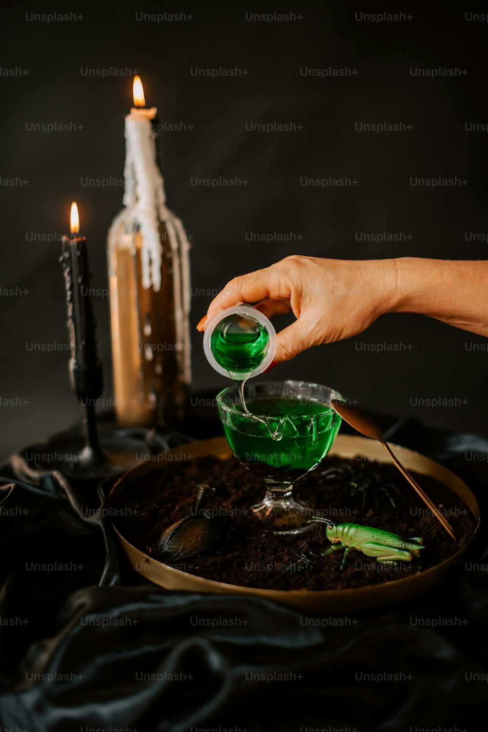 a person pouring green liquid into a bowl