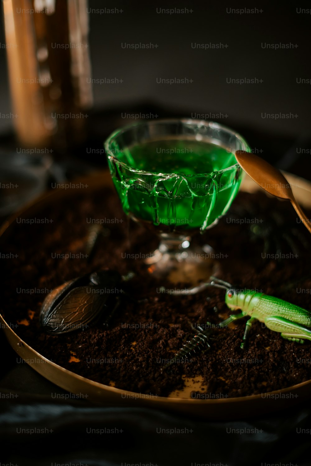 a glass bowl with a green liquid in it