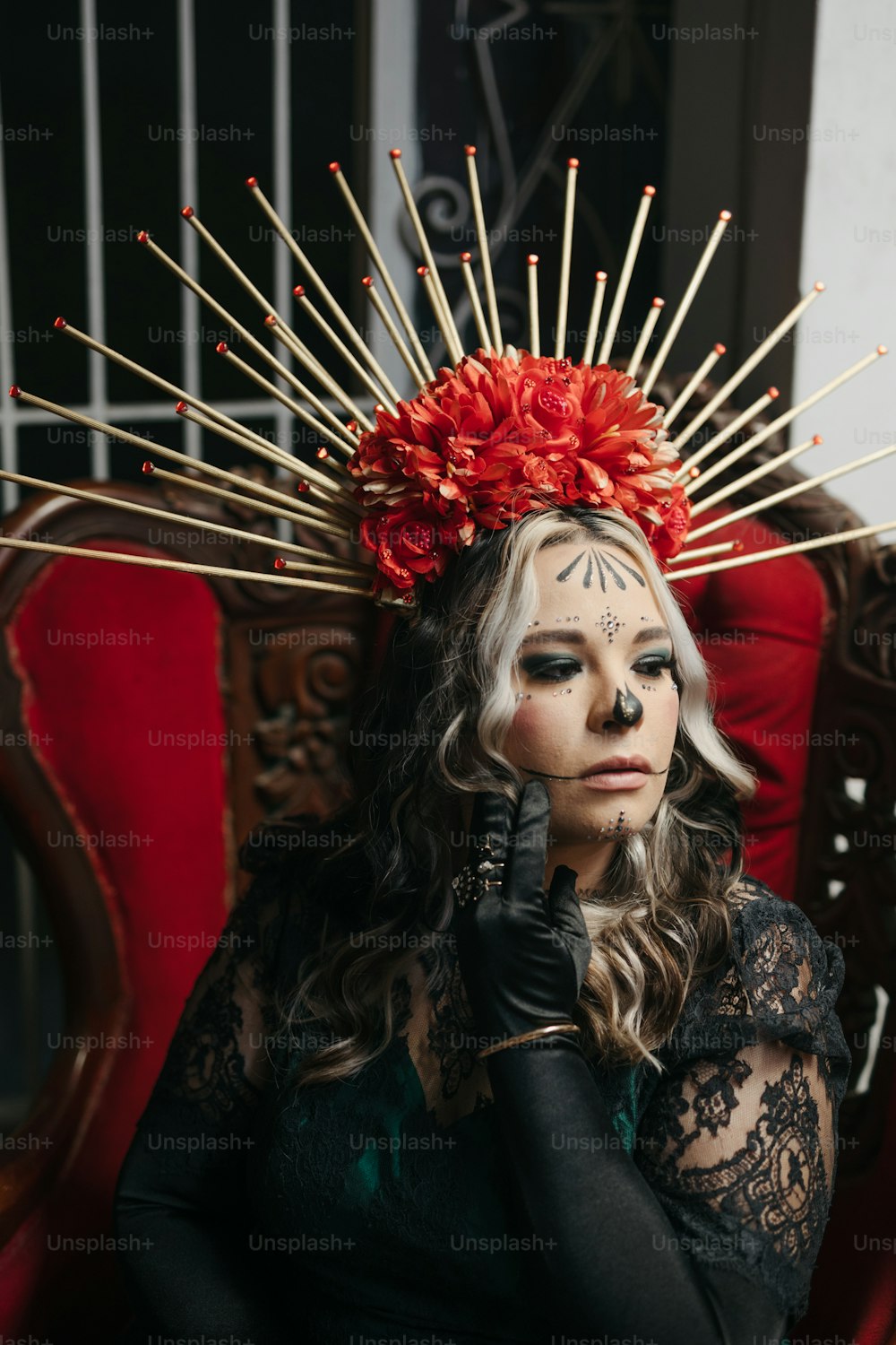 a woman with makeup on her face sitting in a chair