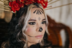 a woman with black makeup and a red flower in her hair