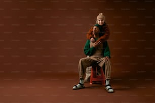 Un uomo seduto sopra una sedia rossa accanto a una donna