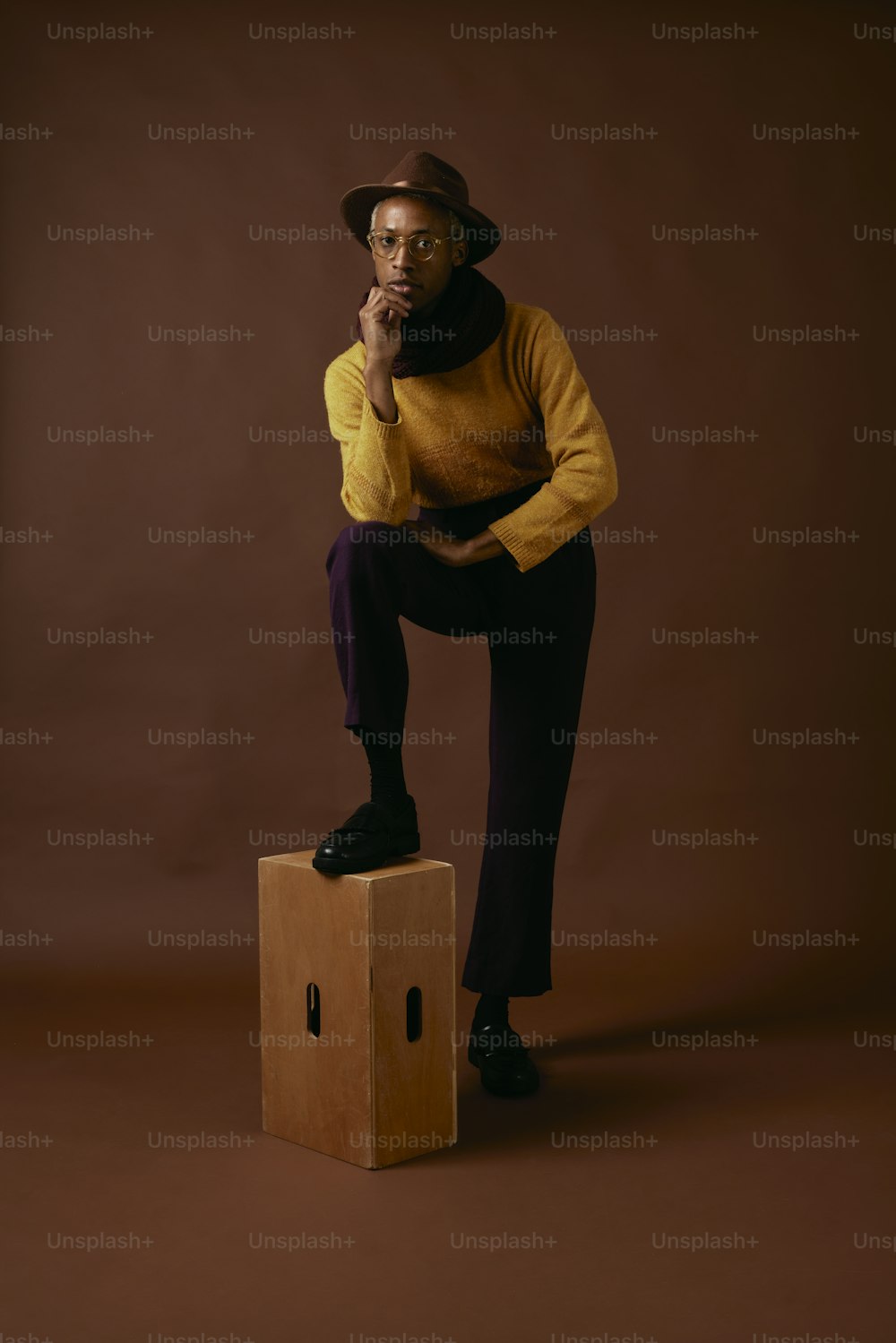 a man sitting on top of a cardboard box