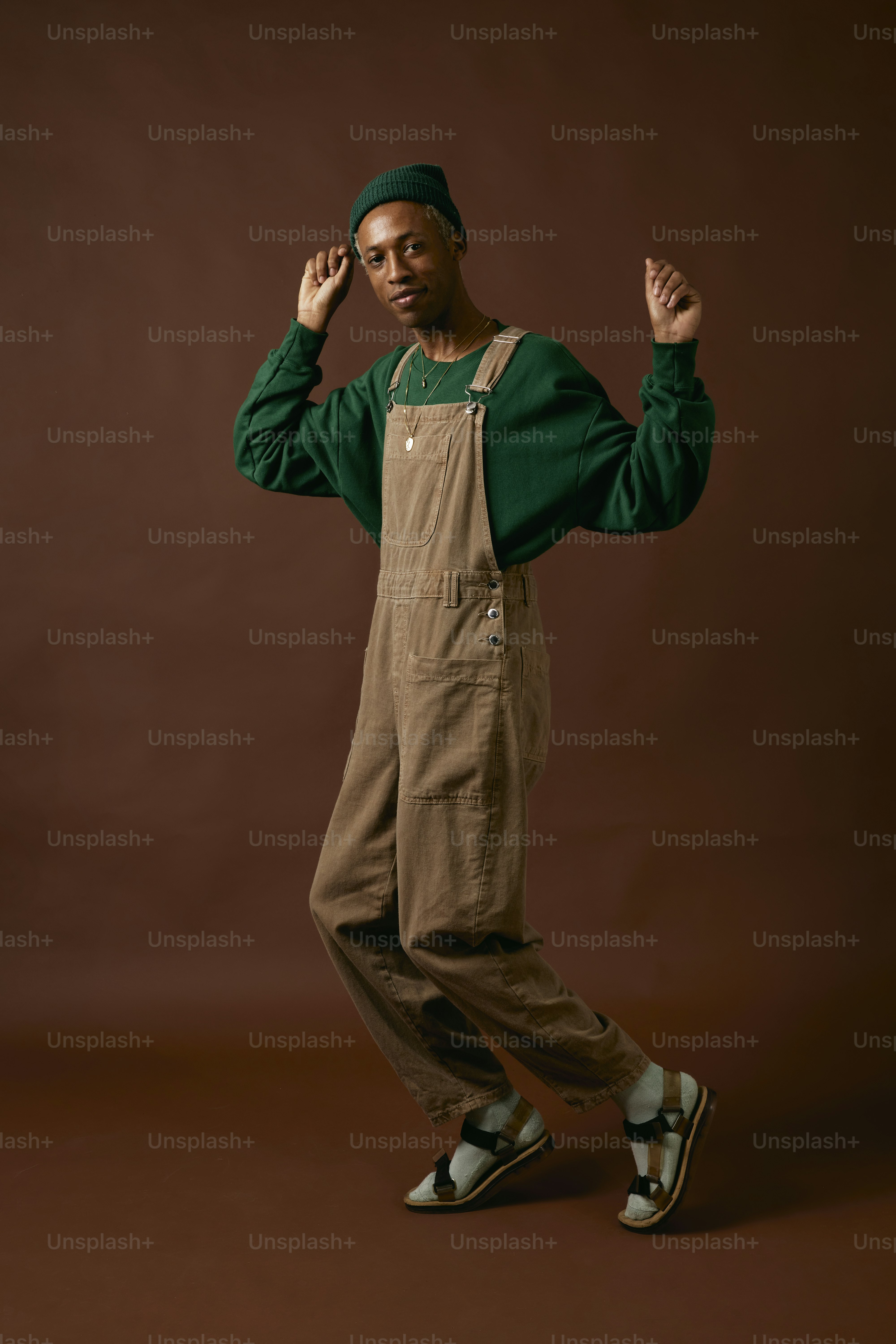 a man in overalls is posing for a picture