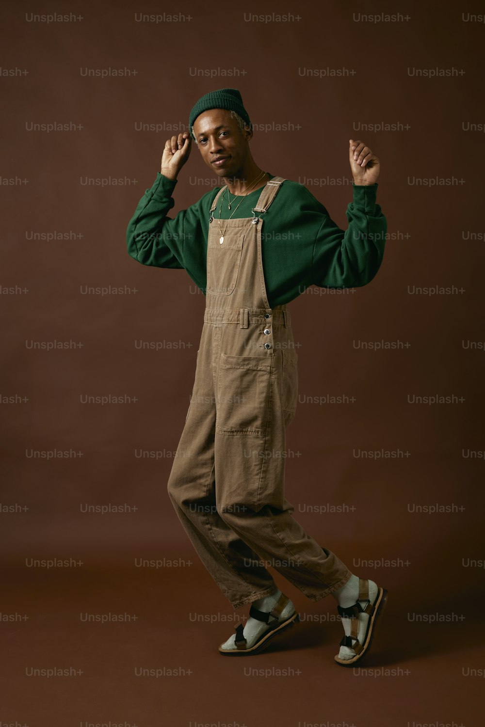 a man in overalls is posing for a picture