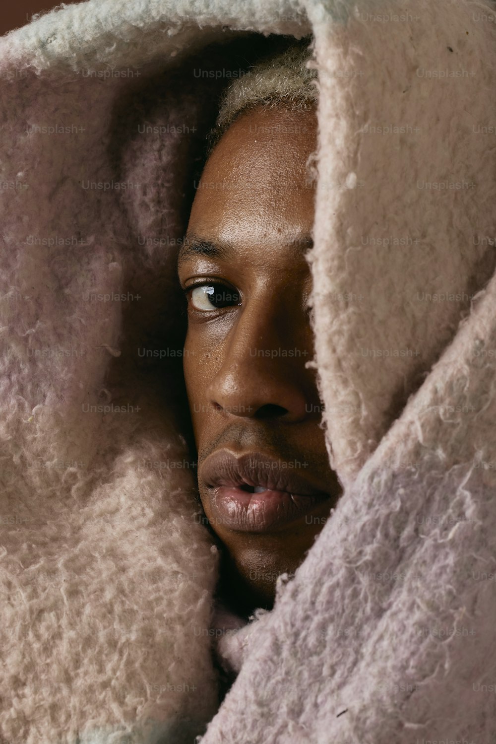 a close up of a person under a blanket