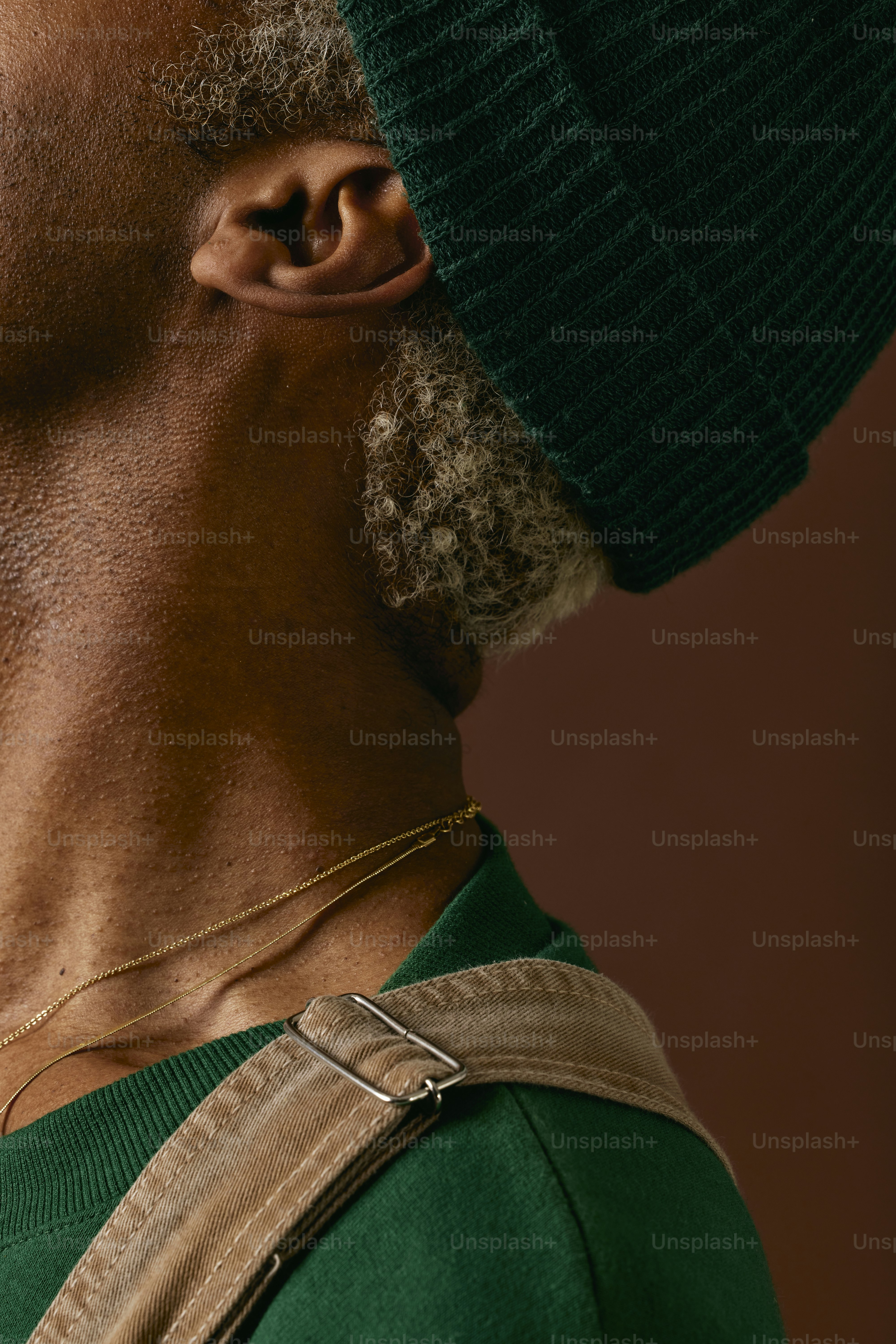 a man with a beard wearing a green hat