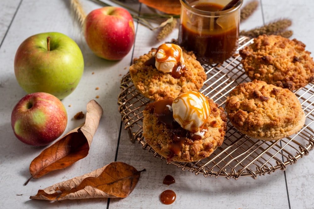 a cooling rack with some cookies and some apples