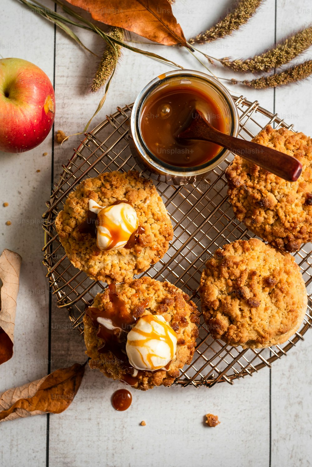 a table topped with cookies and an apple