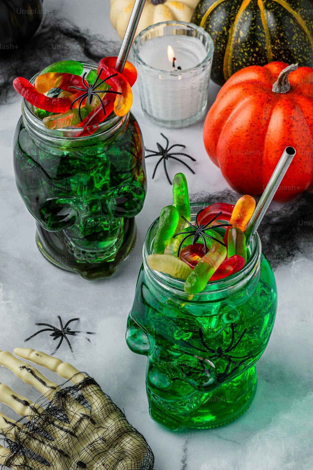 a table topped with two mason jars filled with halloween decorations