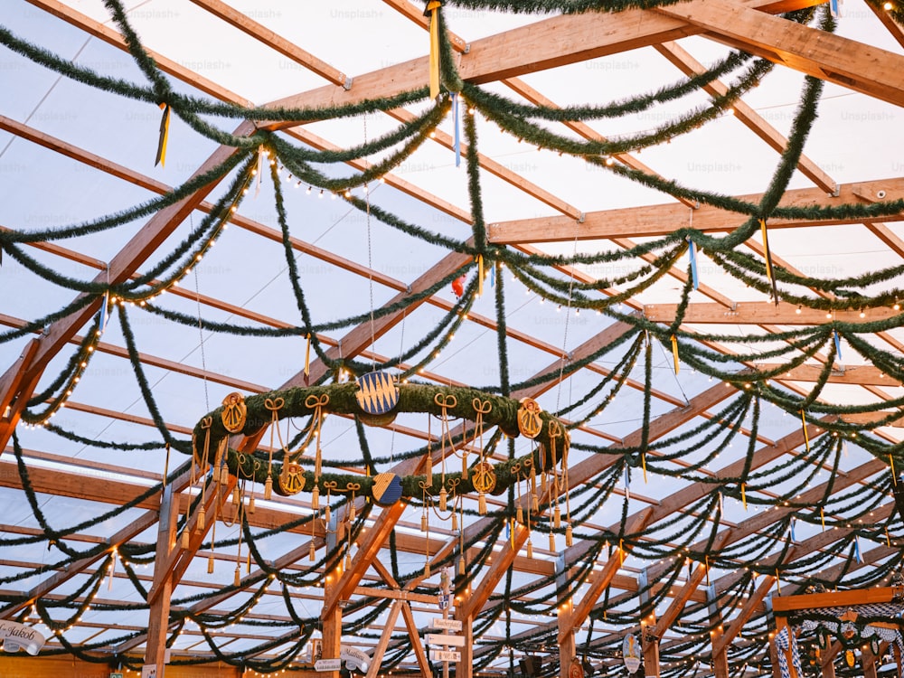 a room filled with lots of wooden beams covered in christmas lights