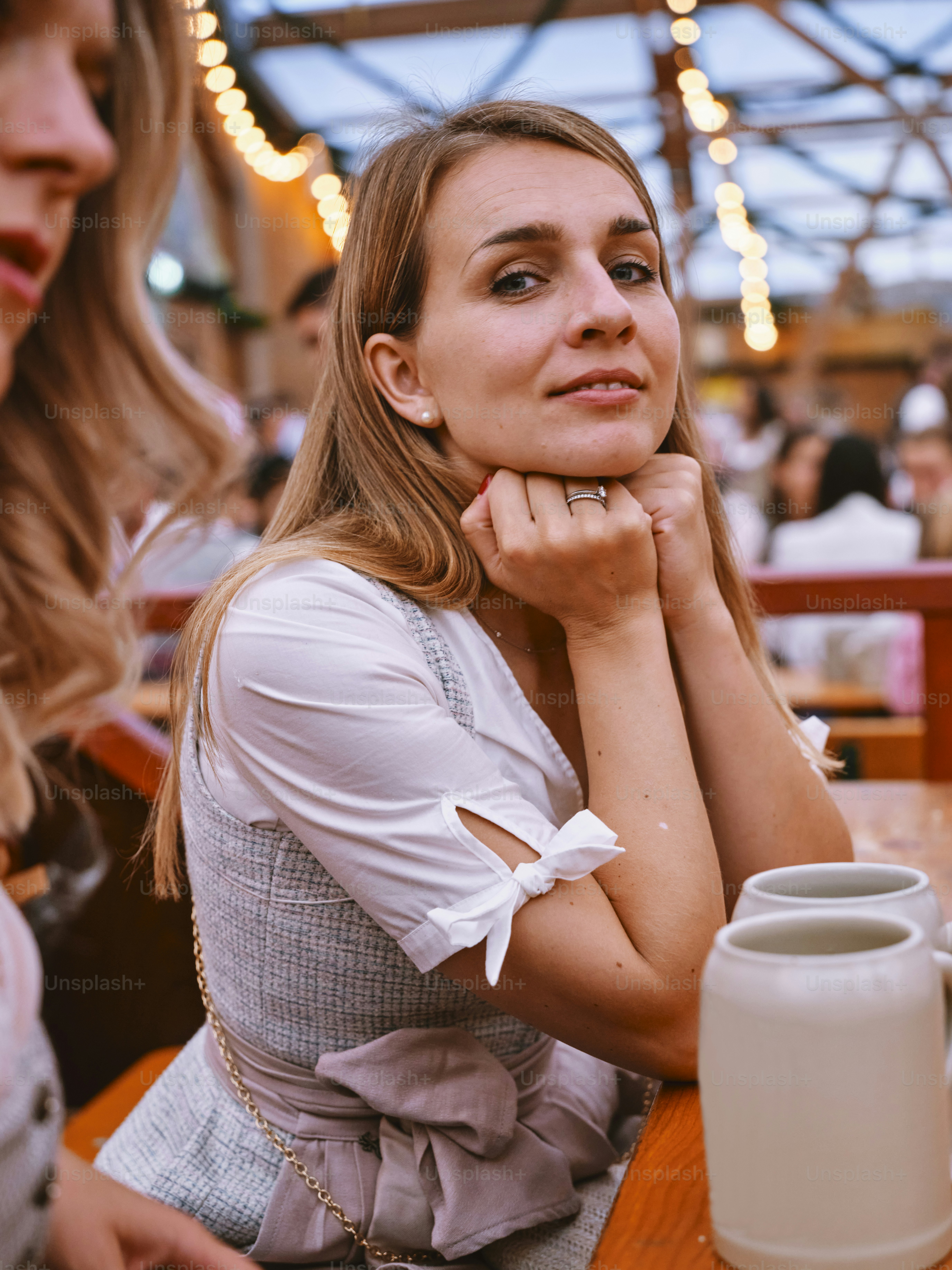 a woman sitting at a table with a cup of coffee