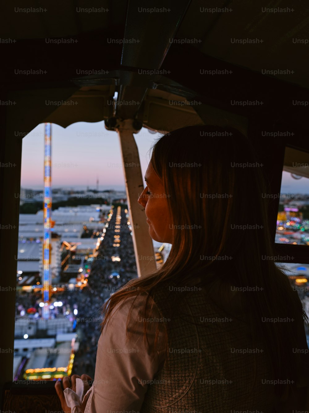 a woman looking out a window at a city